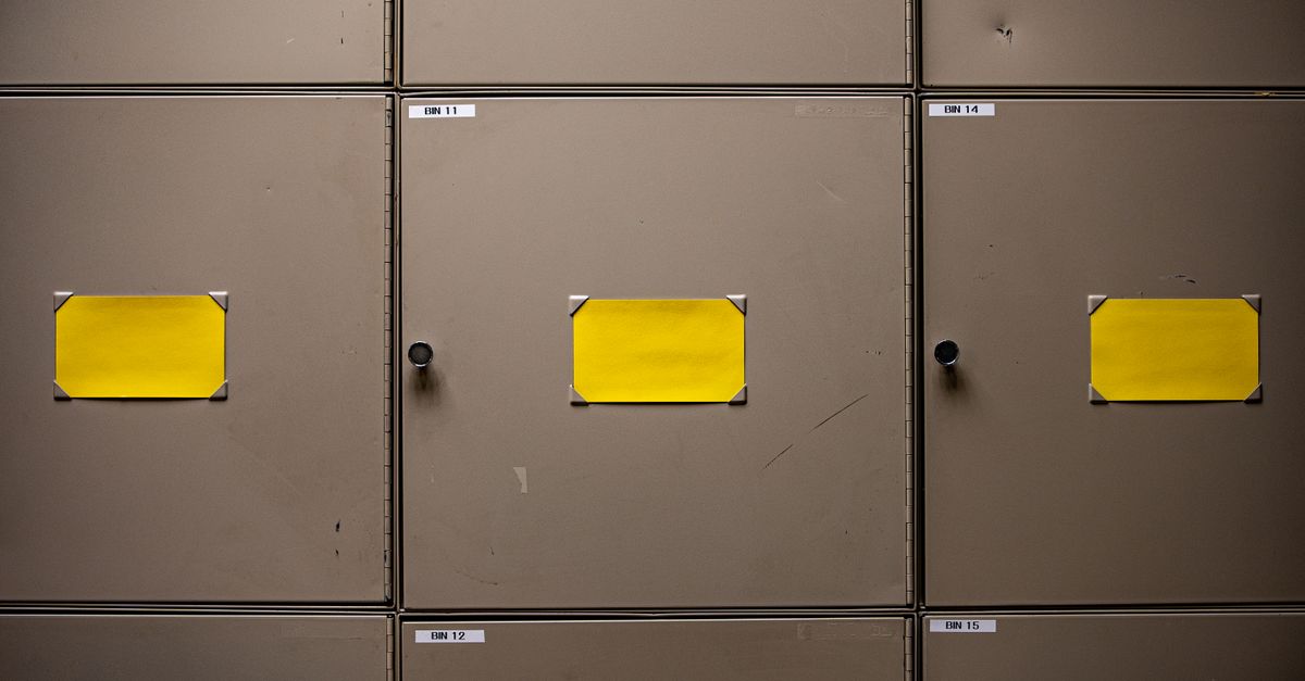 Steel cabinets with yellow labels for organization in an interior setting.