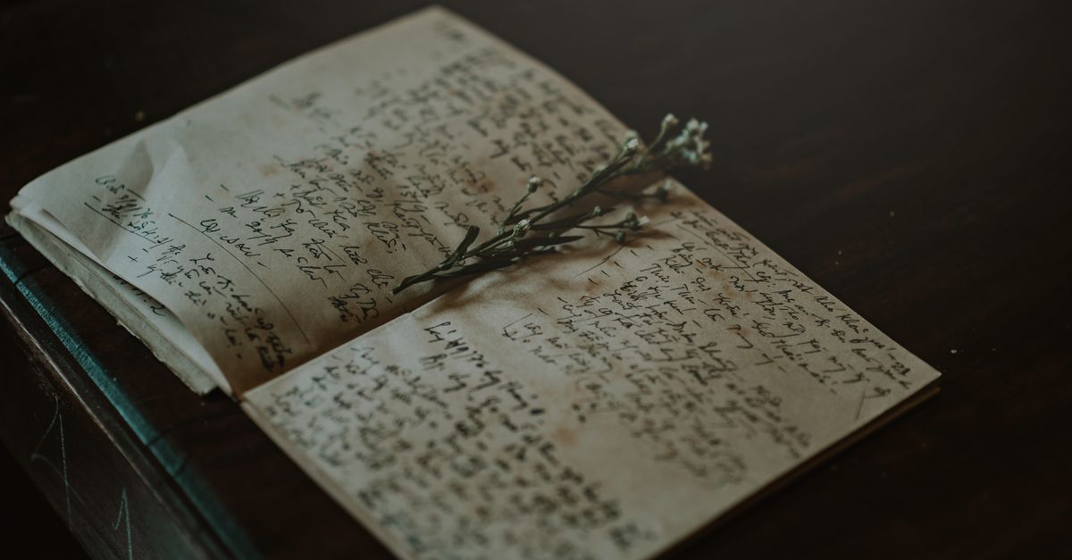 A vintage notebook with handwritten notes and delicate flowers, evoking nostalgia and warmth.